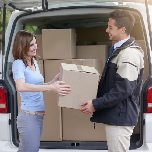 Back of a van two people with parcel to represent the transport industry.
