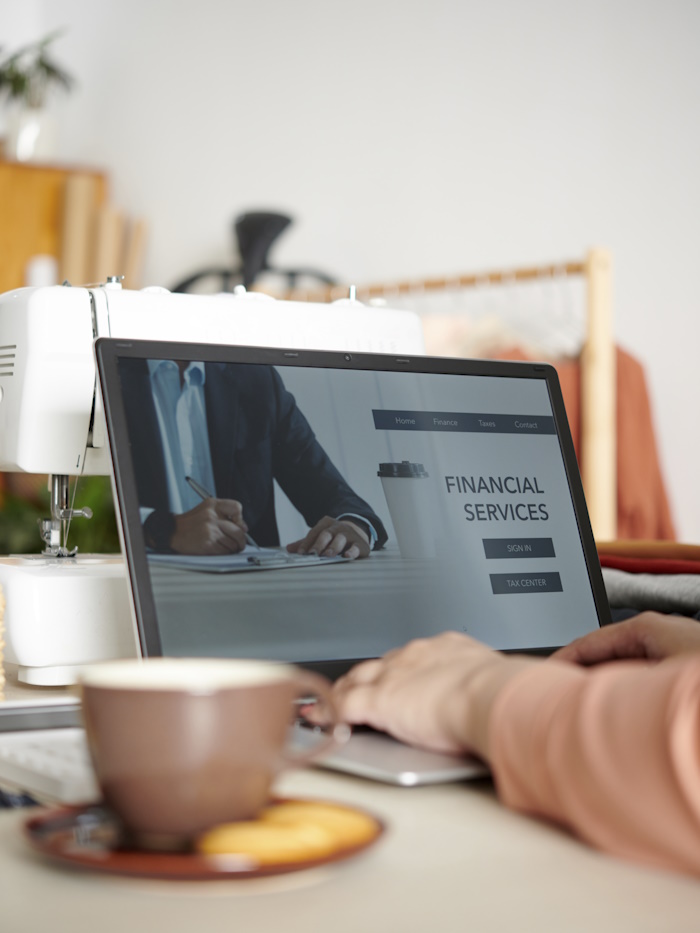 Photo of female using financial services on a laptop.
