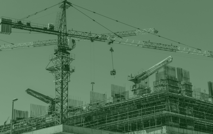 Photo of a crane on a building site.