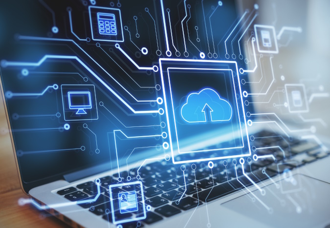 Photo of a laptop with overlay of a cloud and computer icons.