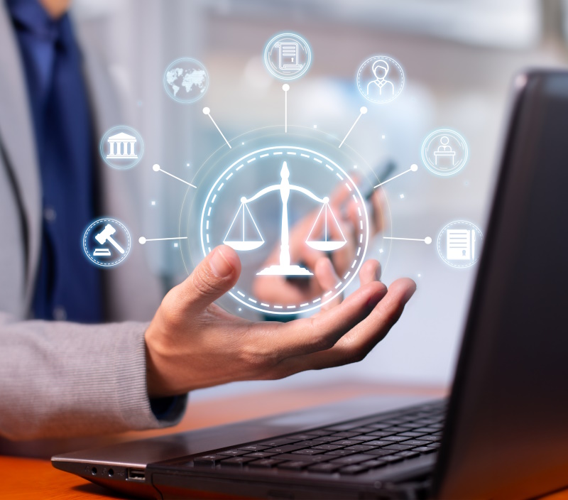 Photo a laptop and a man hands holding a overlay of legal, regulations iocns.